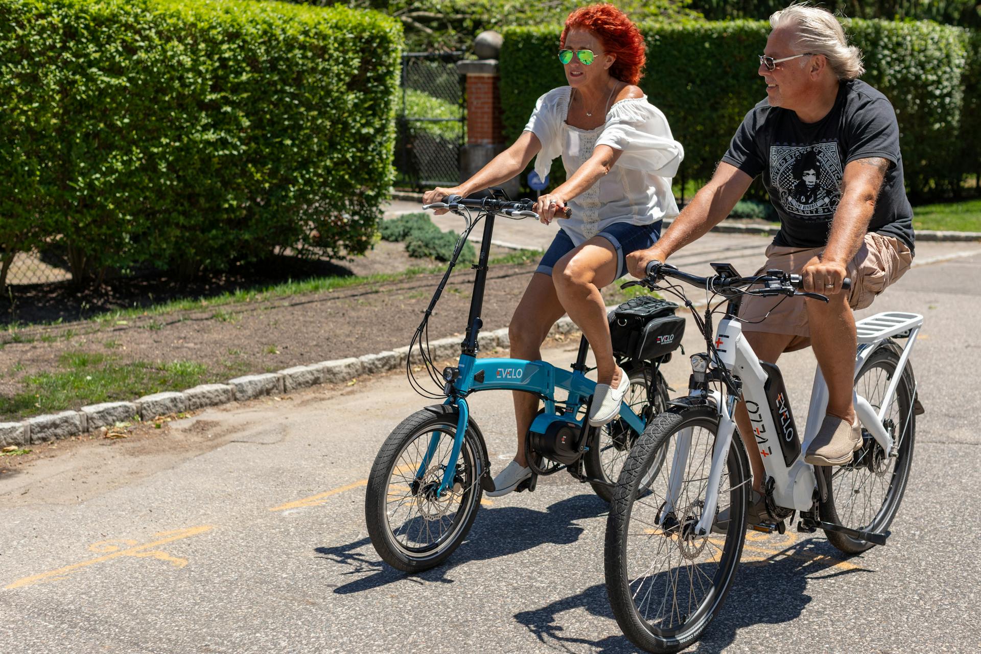 Two people riding bicycles on a paved road