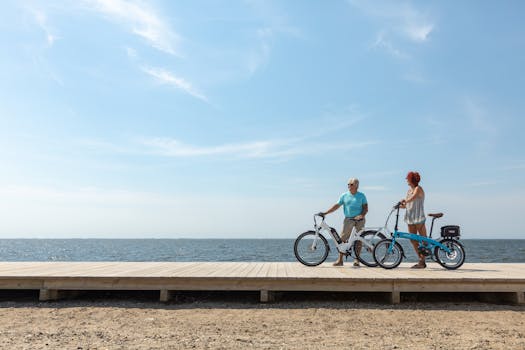 A couple enjoying a leisurely ride on electric bicycles along a beach boardwalk in Patchogue, NY.