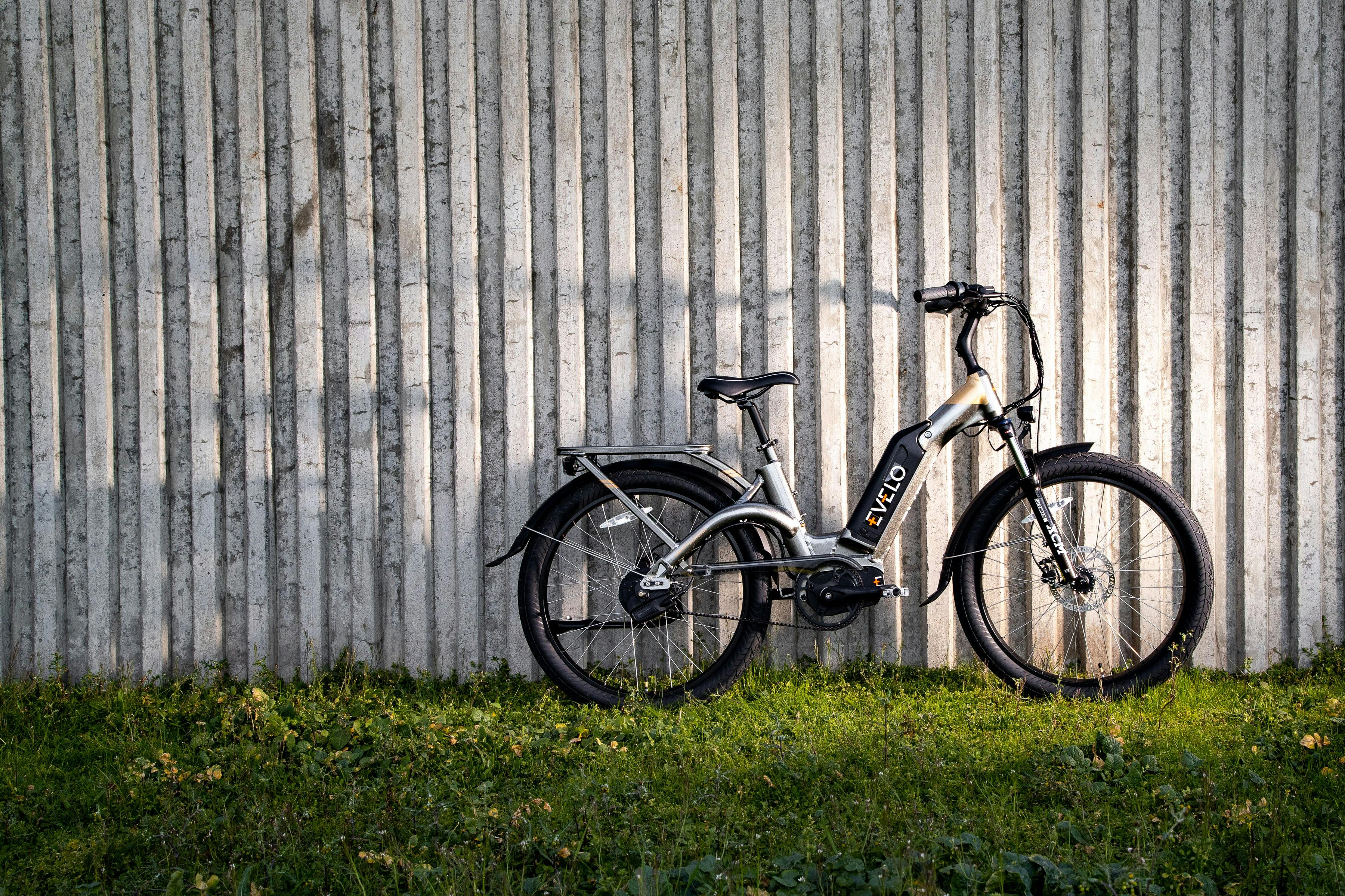 a bicycle parked against a wall in front of a building