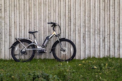 Black Bicycle Parked Beside a Concrete Wall