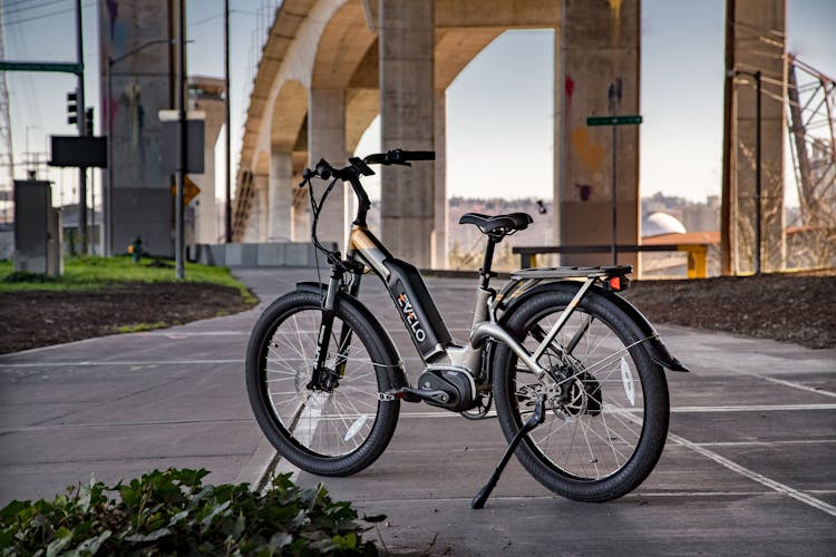 Black Electric Bike Parked On Gray Concrete Pavement