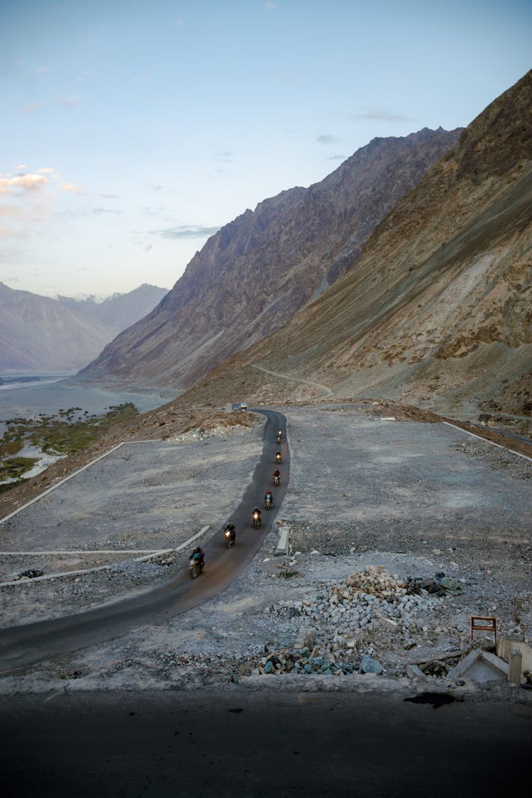 Aerial Photography Of Motorcycles Moving On The Road On The Foot Of A Mountain