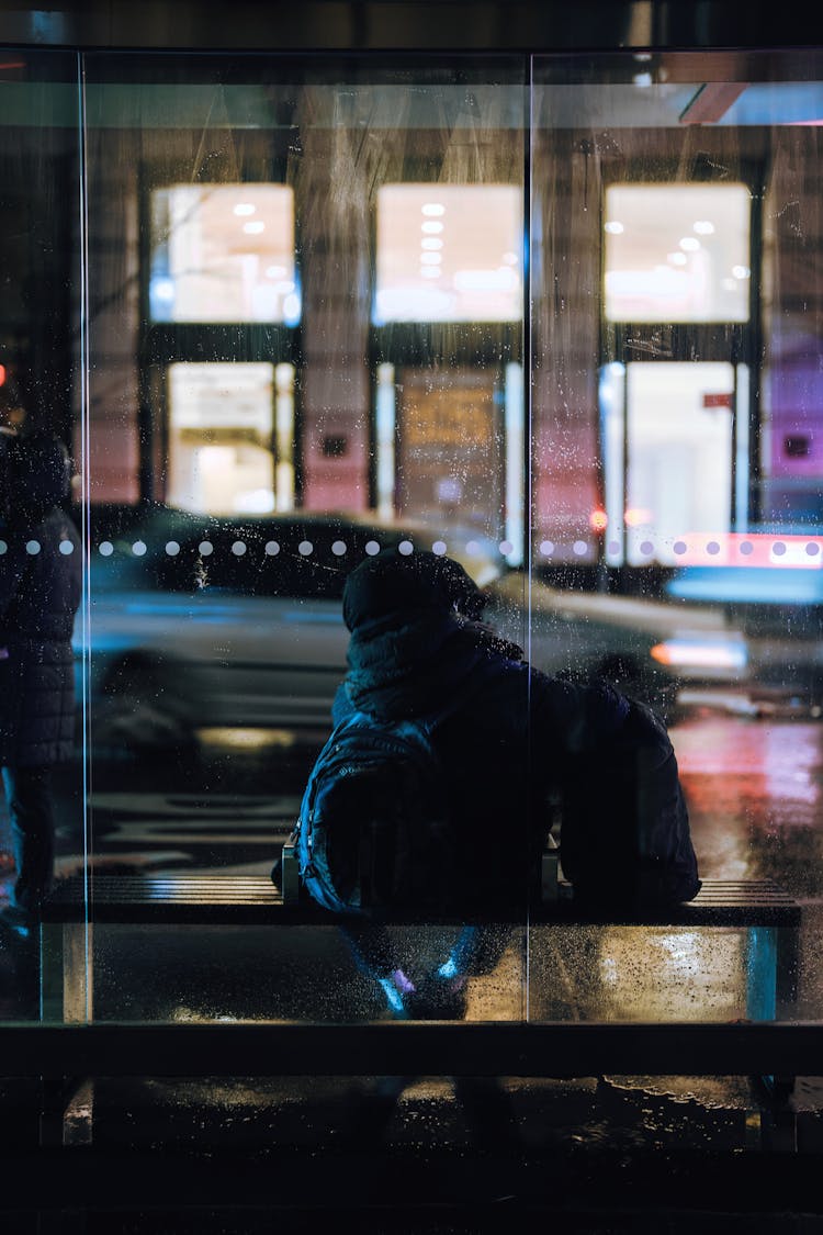 Man Standing On Bus Stop At Night