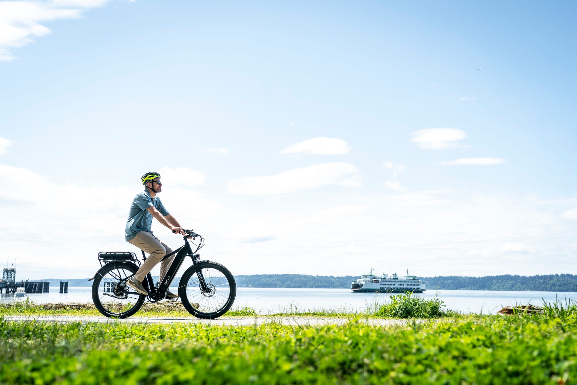 A man riding an electric bike on a grassy field