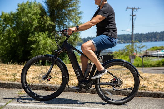 A person rides an electric bike on a sunny day near a Seattle lake.