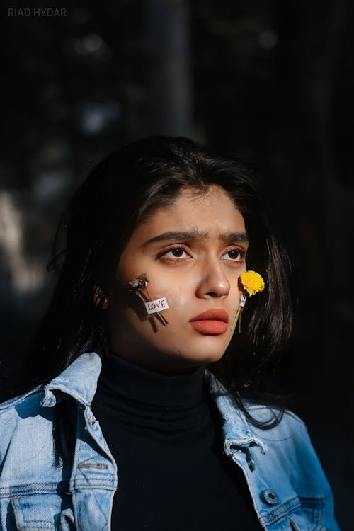 Flowers Taped on a Woman's Cheek
