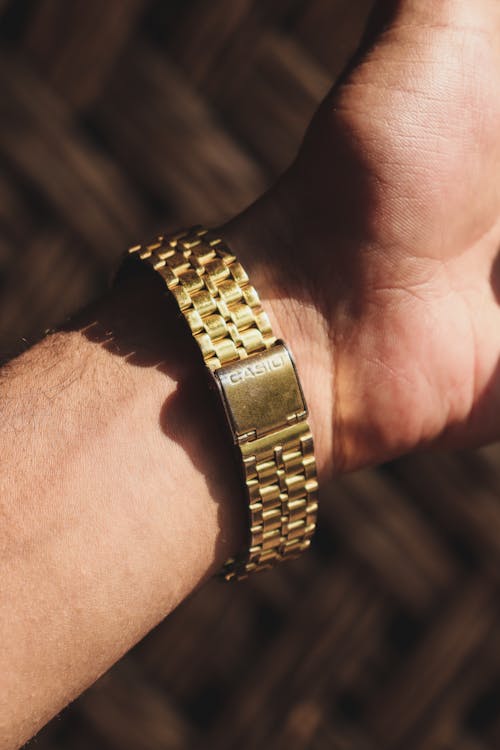 A Person Wearing a Gold Watch