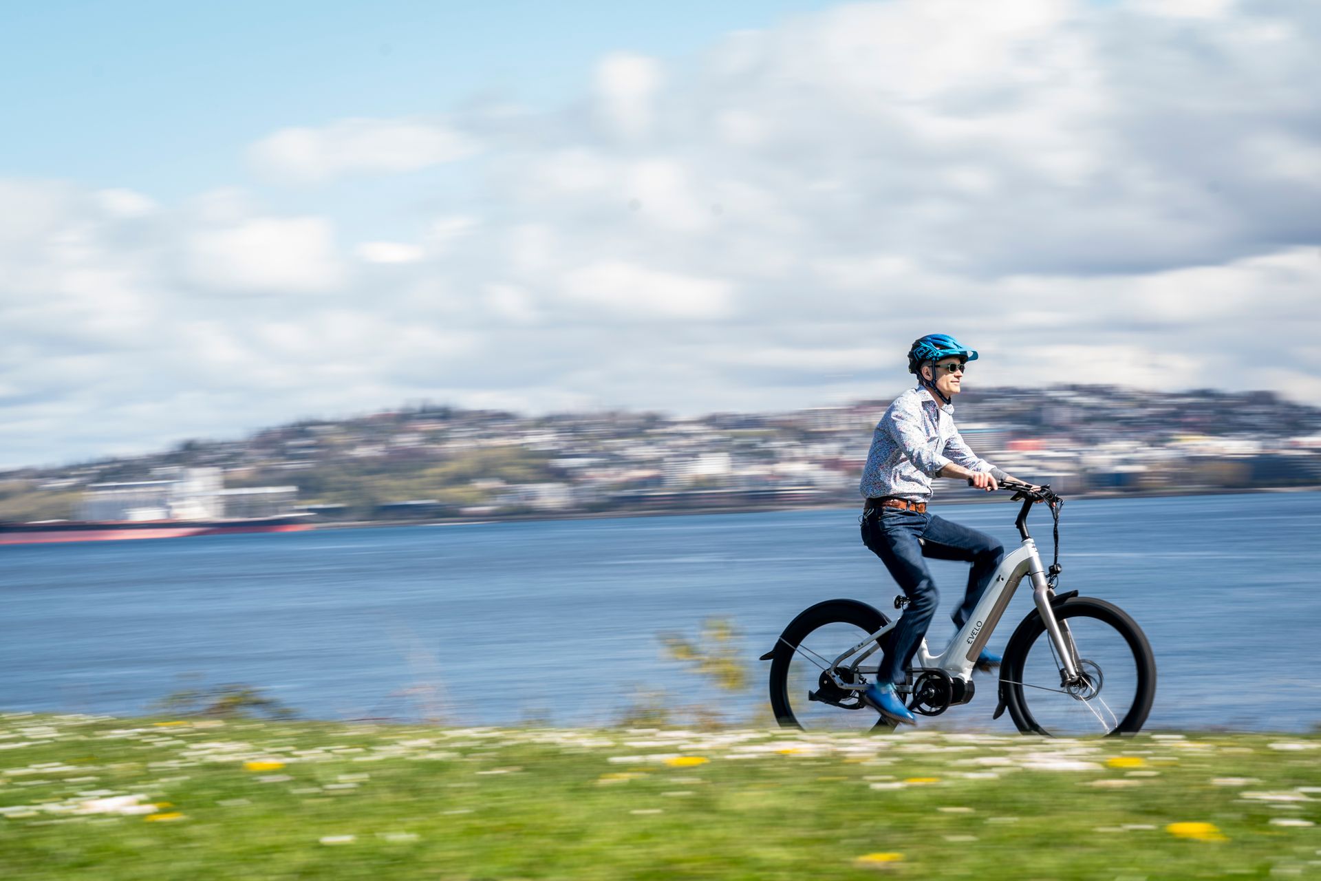 A person riding an electric bike on a grassy field