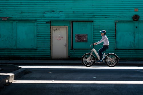 A Man Riding Electric Bicycle on the Street