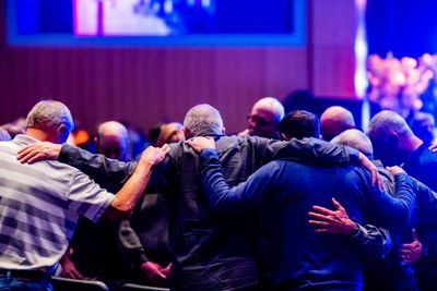 Congregation in prayer, heads bowed