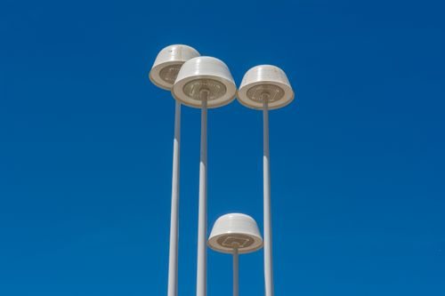 Free Minimalist street lamps set against a blue sky, showcasing urban design and architecture. Stock Photo
