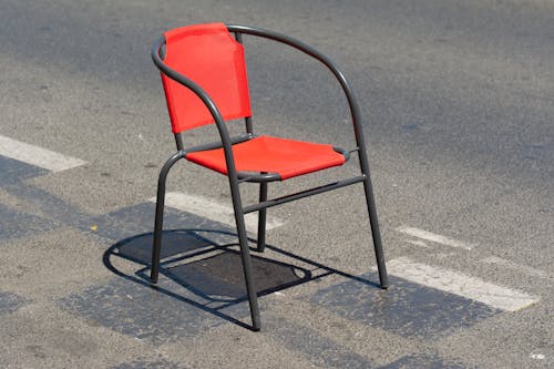 Empty Chair on Asphalt Road