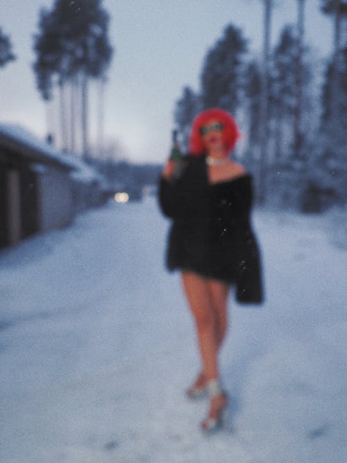 A Woman Standing Outdoors in Winter 