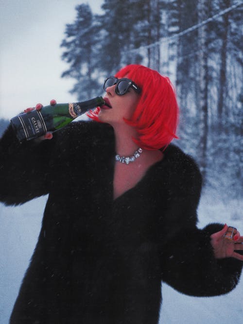 Woman Drinking Champagne Outdoors in Winter