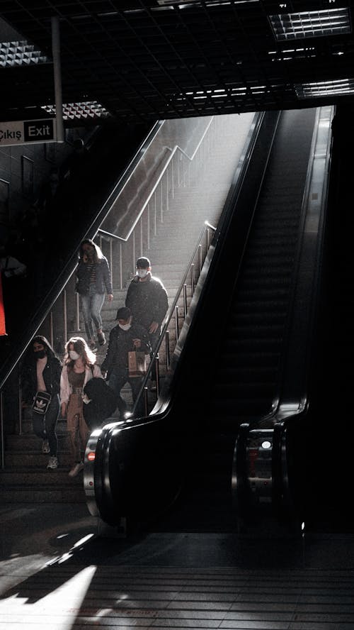 People Walking down Stairs in Subway