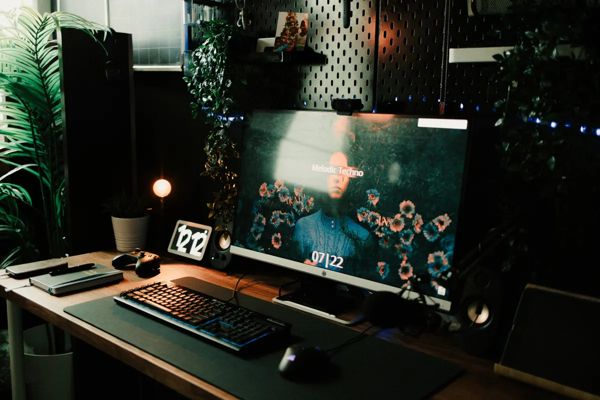 A home office desk setup with a laptop and monitor, representing the workspace where many active traders qualify their trading activity as a business