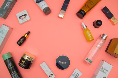 Stylish beauty products arranged on pink table