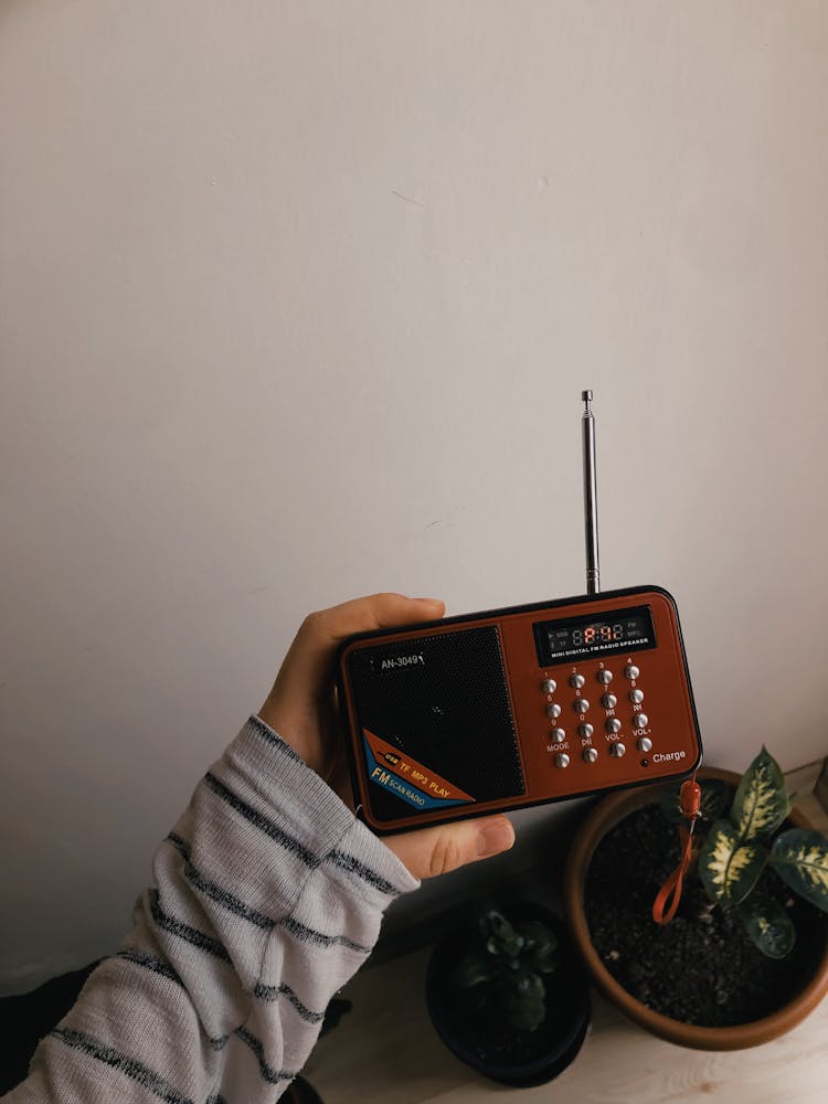 A Person Holding A Radio 