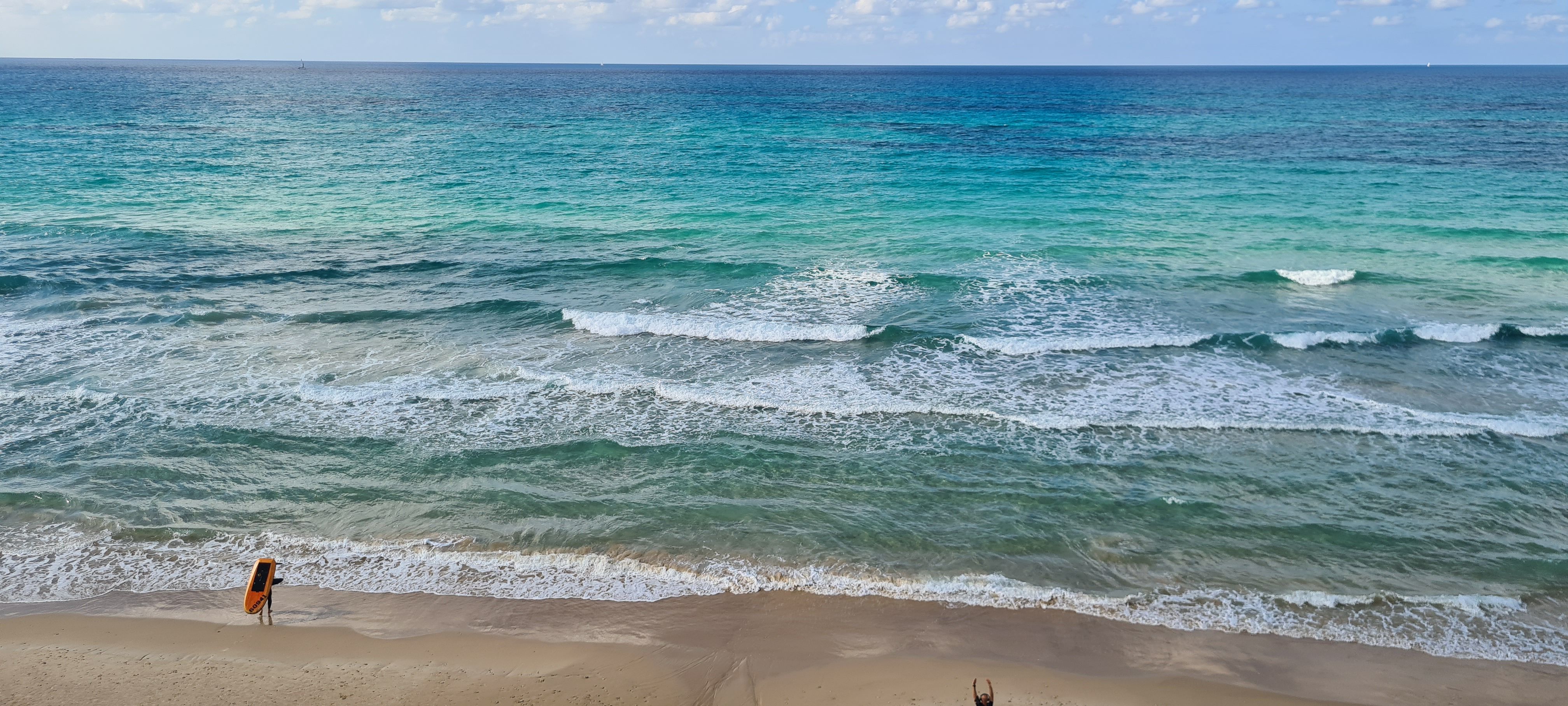 People enjoying a vibrant summer day on Tel Aviv beach, Israel