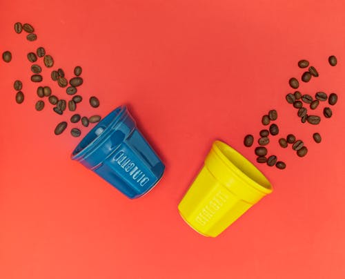 Coffee Beans Scattered by Cups 