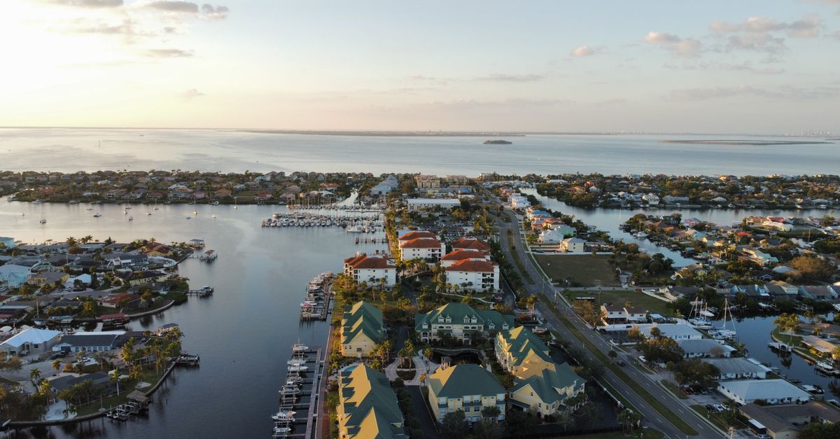 Aerial view of Apollo Beach, FL showcasing the waterfront community and marina at sunset.