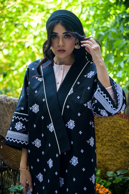 A Woman Wearing a Headscarf and Floral Print Robe