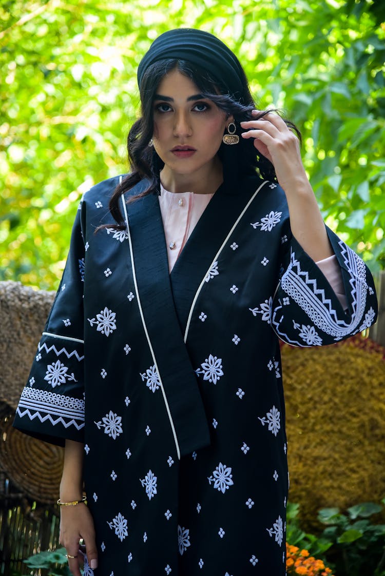 A Woman Wearing A Headscarf And Floral Print Robe