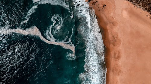 Drone Shot of Waves Near the Sand