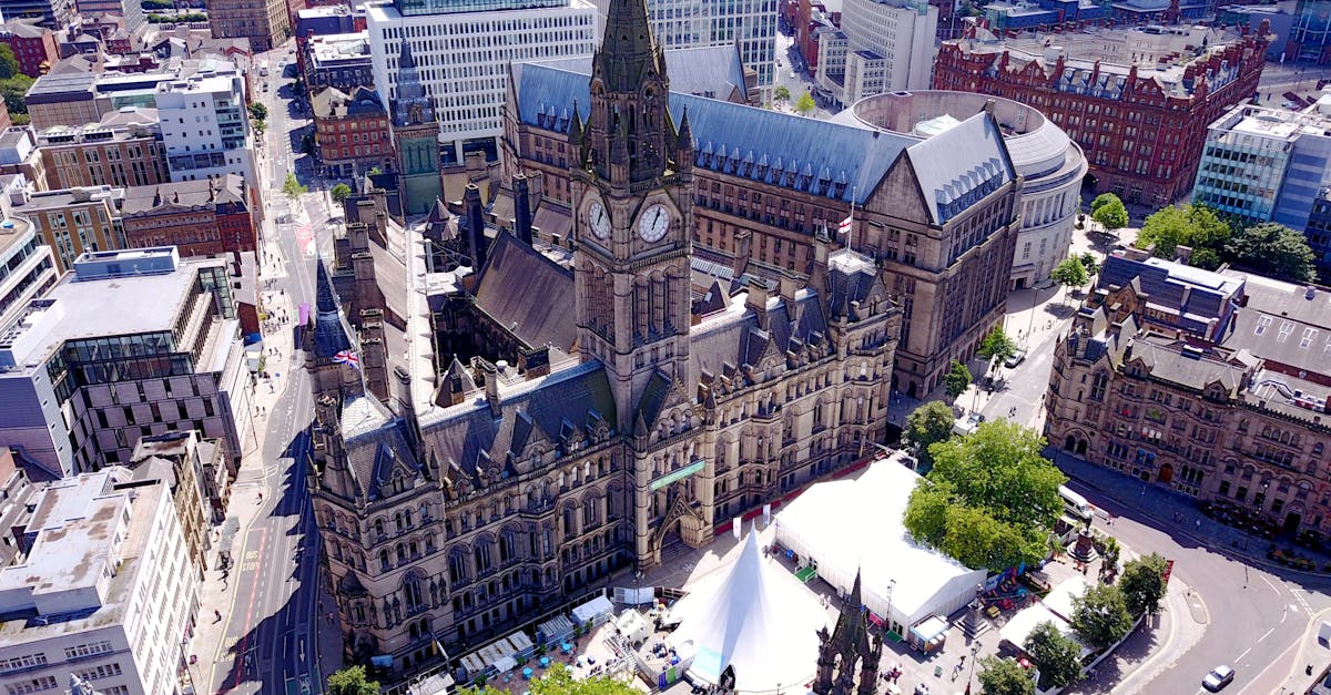 Aerial view of the iconic Manchester Town Hall and surrounding cityscape in the United Kingdom.