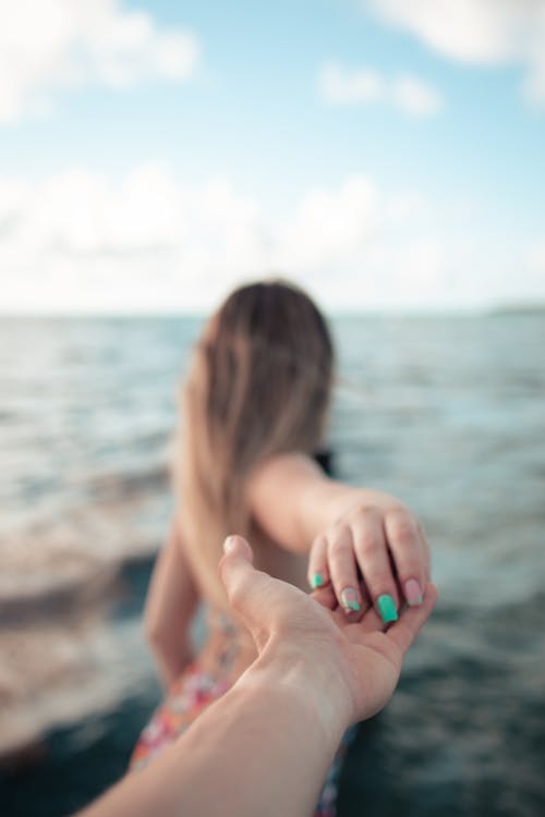A Person Holding Woman's Hand
