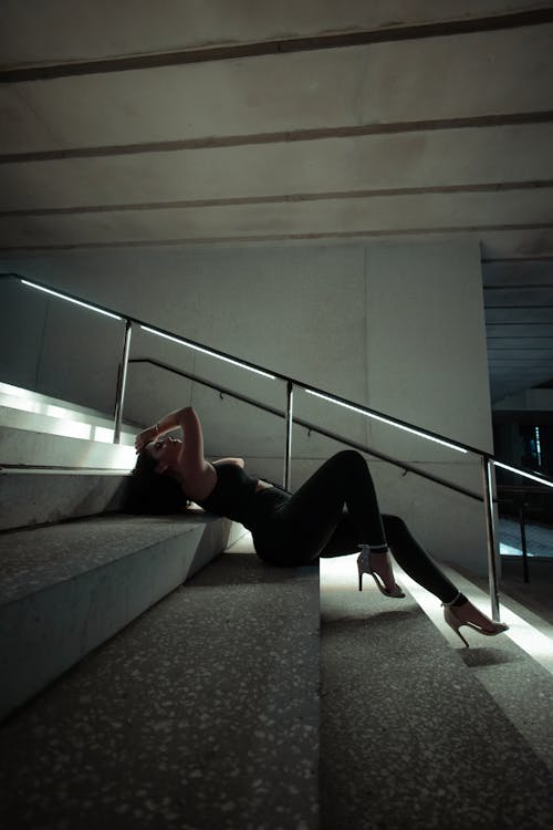 Woman Lying on Gray Concrete Stairs