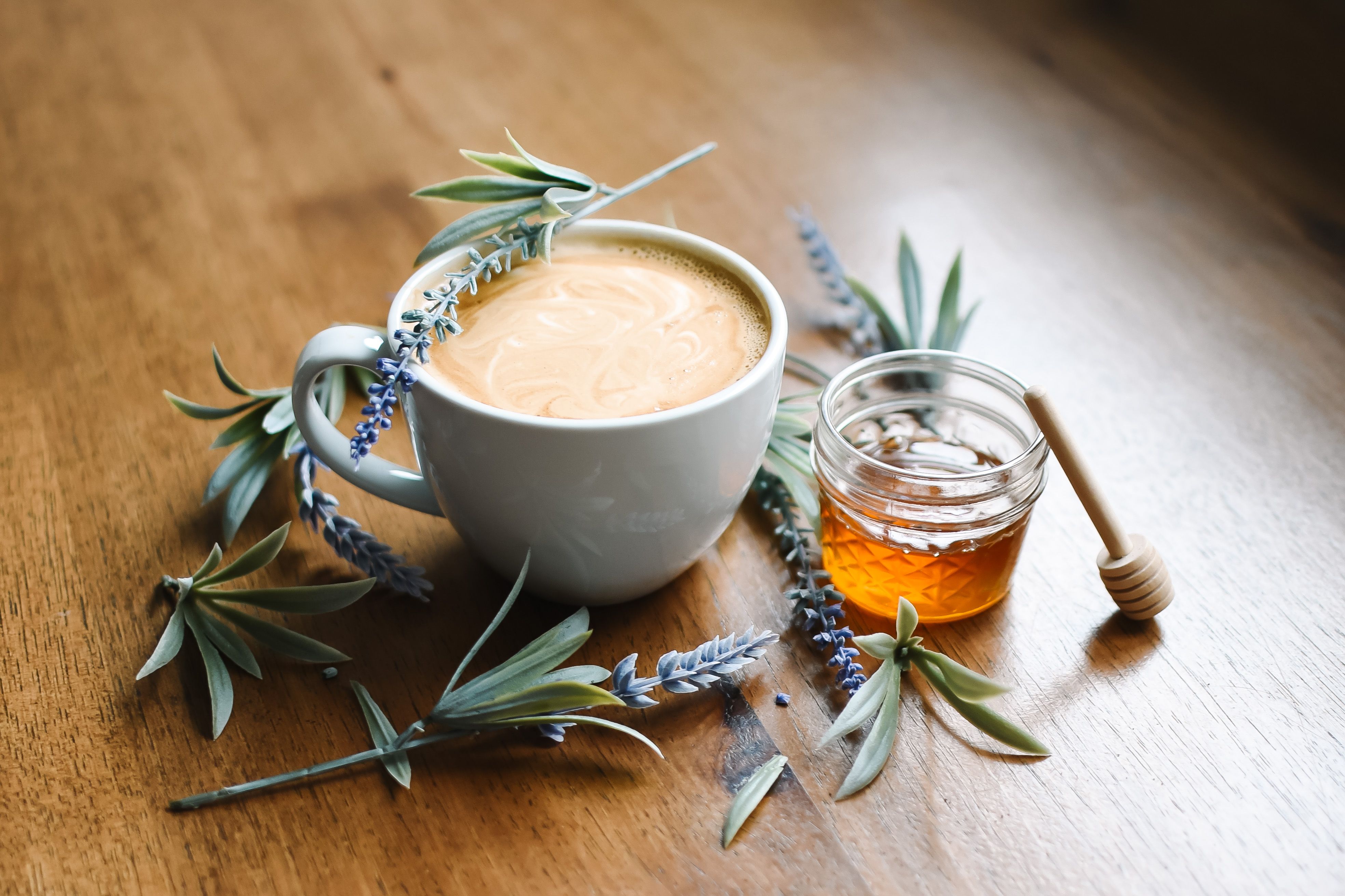 Free A beautifully styled latte with honey and lavender on a wooden table. Stock Photo