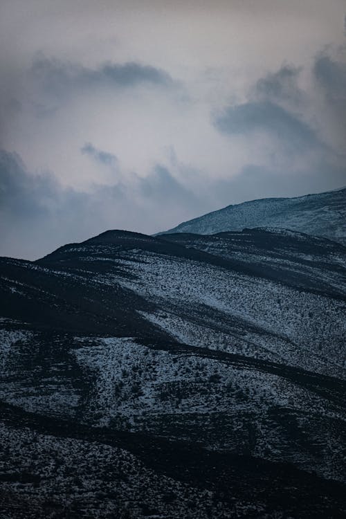 Aerial Photography of Snow-Covered Mountains under the Cloudy Sky