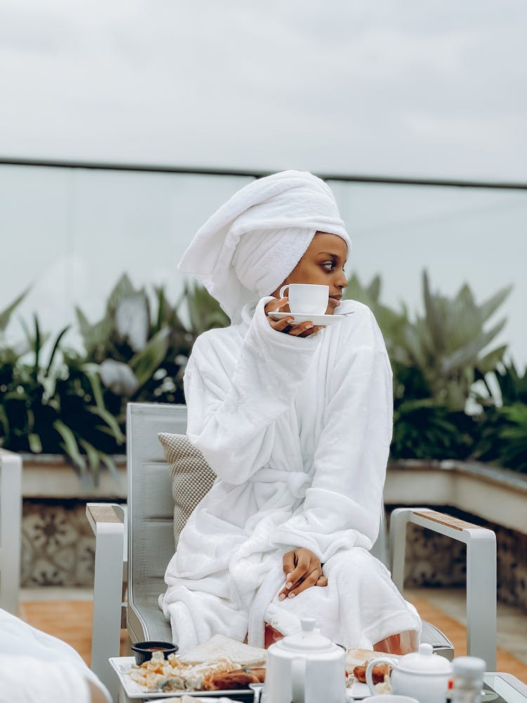 Woman In Bathrobe Drinking Coffee In Hotel