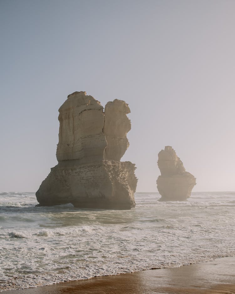 Rocks In Ocean On Sunset