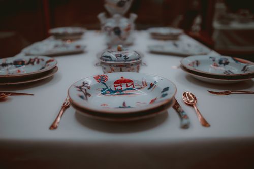 Free Close-up of a sophisticated porcelain place setting with intricate designs on a dining table. Stock Photo
