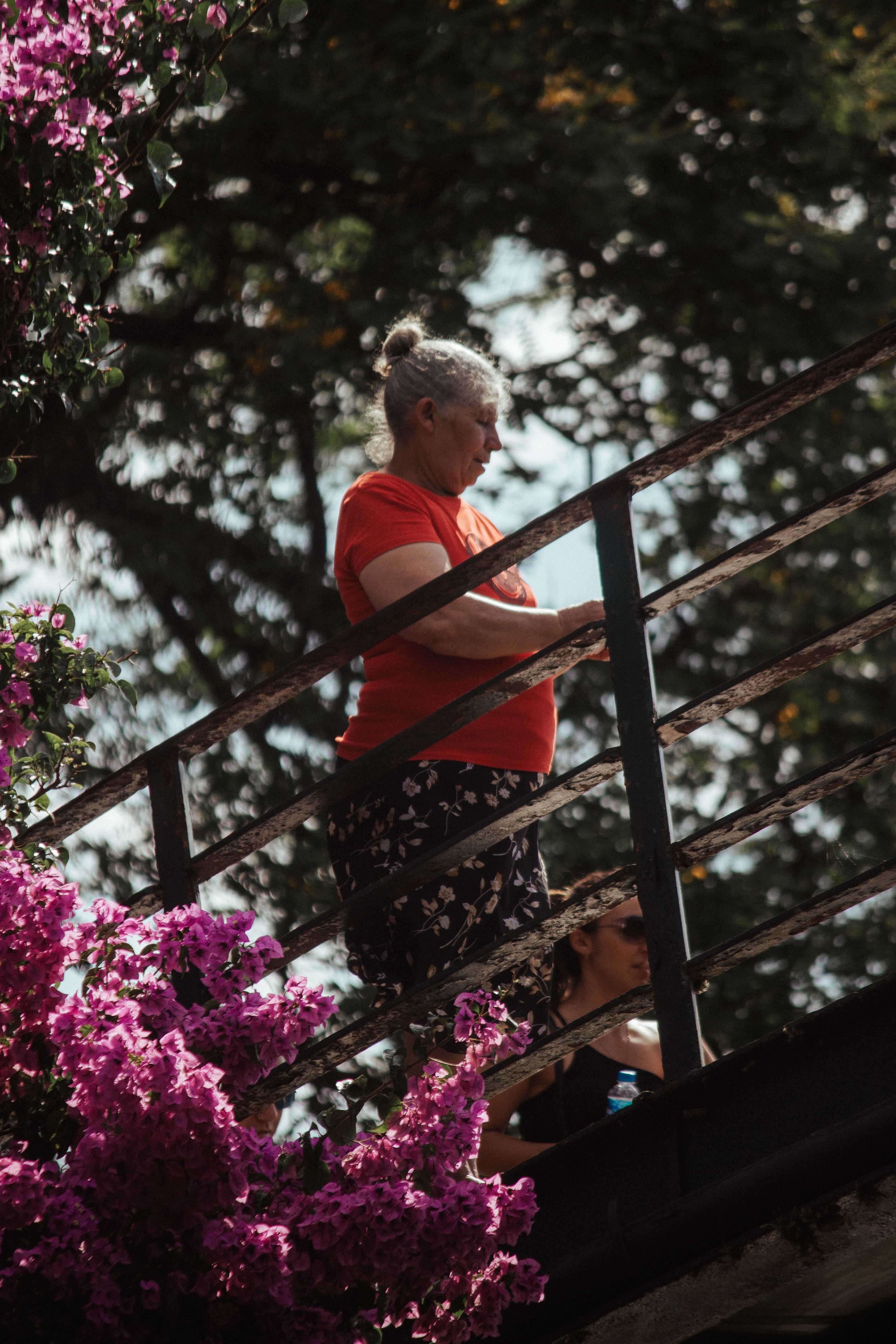 Elderly Woman Standing near a Railing · Free Stock Photo