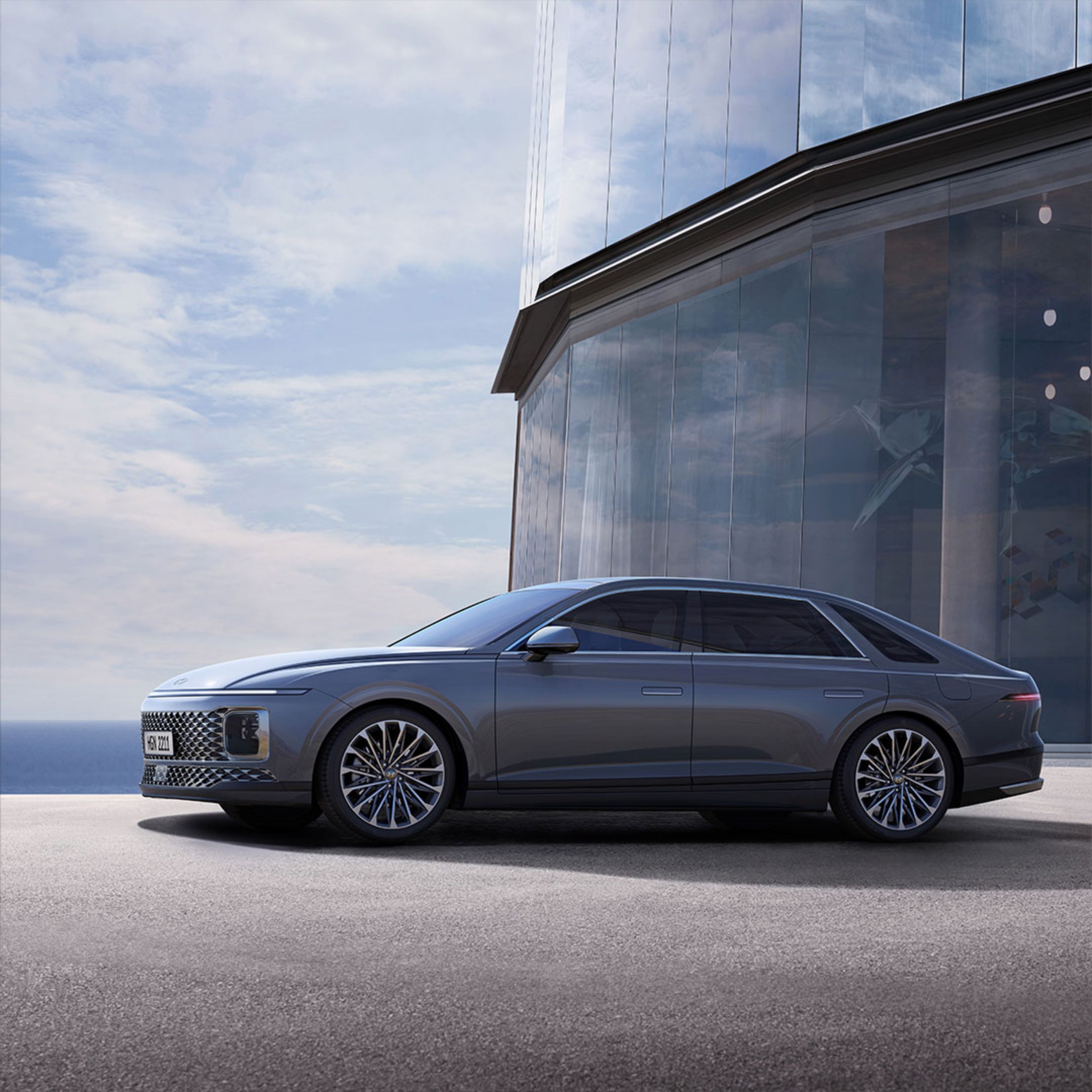 A Gray Hyundai Grandeur Parked Near the Glass Building · Free Stock Photo