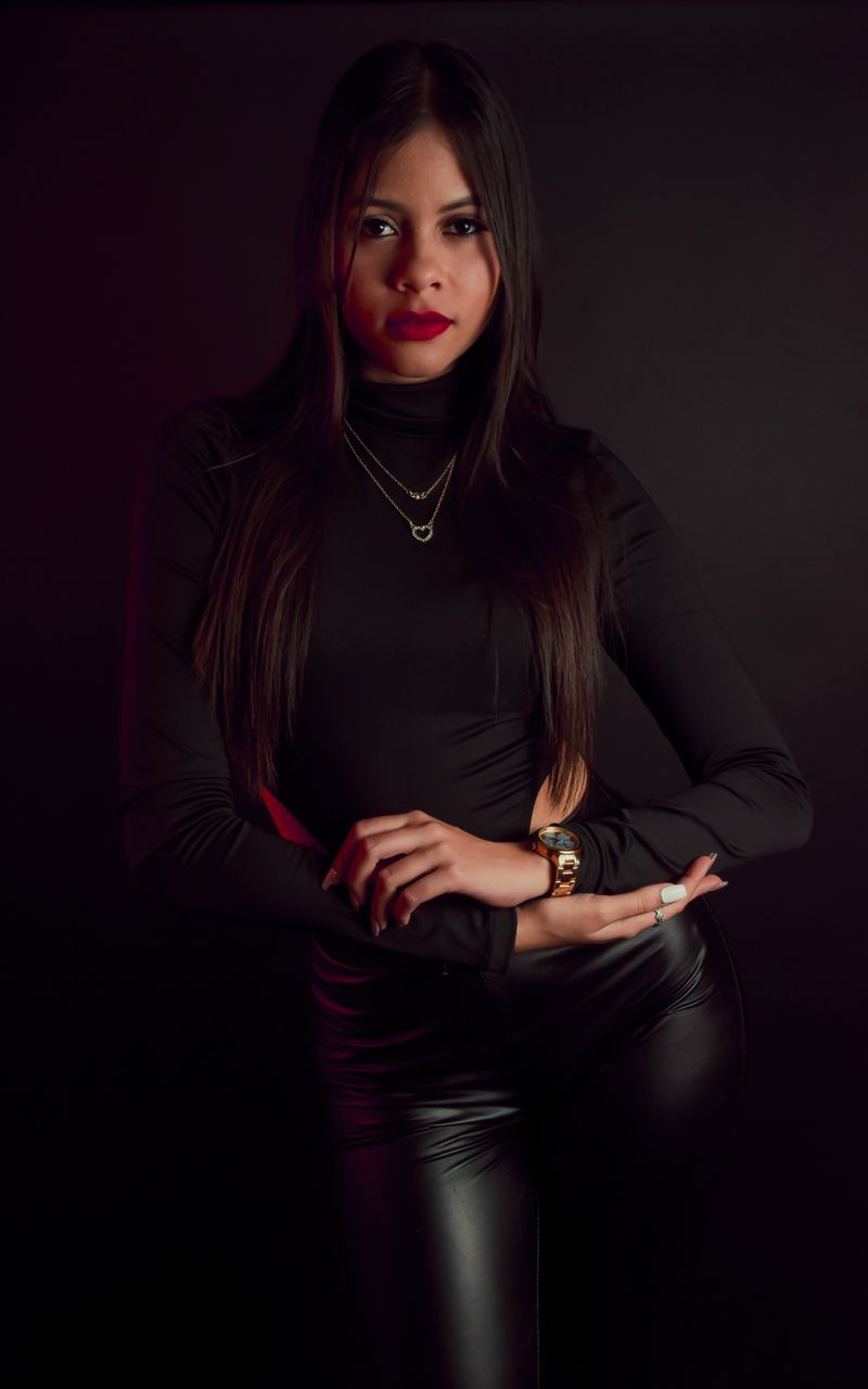 Woman in black long sleeve top and leather pants