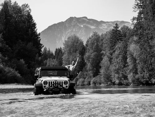 Free A Jeep crossing a scenic river with mountains in Boston Bar, BC. Stock Photo
