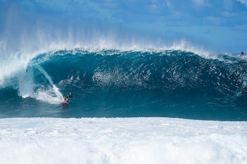 Person Surfing on Body of Water