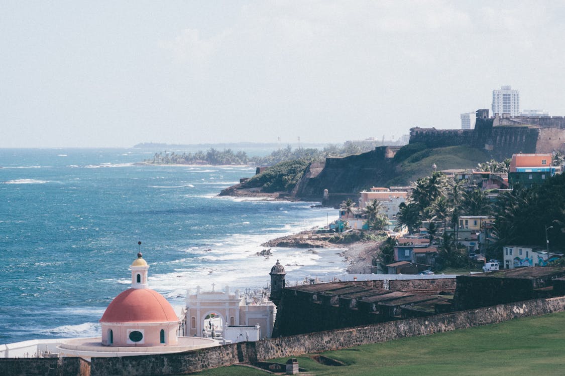 Photo of a Sea With Lighthouse on Daytime