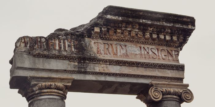 Close-up of ancient Roman ruins in Sicilì, Italy showcasing detailed stone columns and inscriptions.