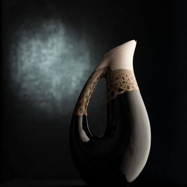 Sculptural ceramic vessel on a dark backdrop by Vural Yavas on Pexels