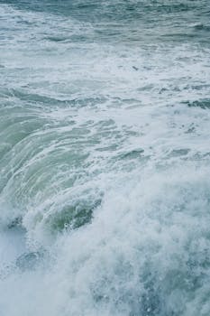 An immersive view of ocean waves in motion, showcasing white foam and natural beauty.