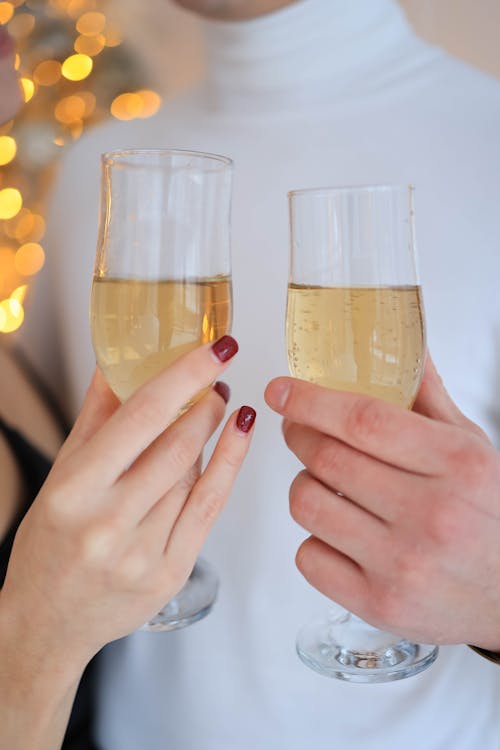 A Close-Up Shot of a People Toasting with Glasses of Champagne