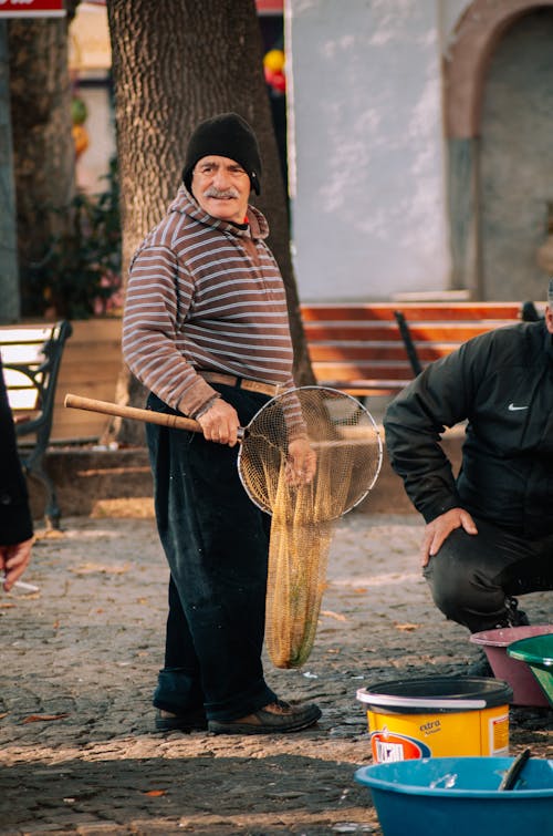 A Man Holding a Fishnet