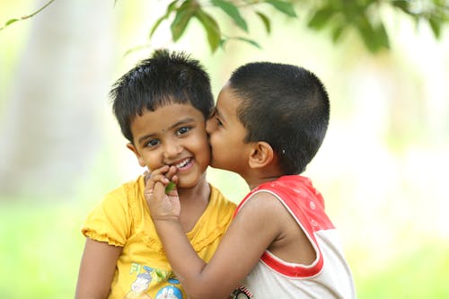 Free Toddler Kissing Smiling Girl Stock Photo