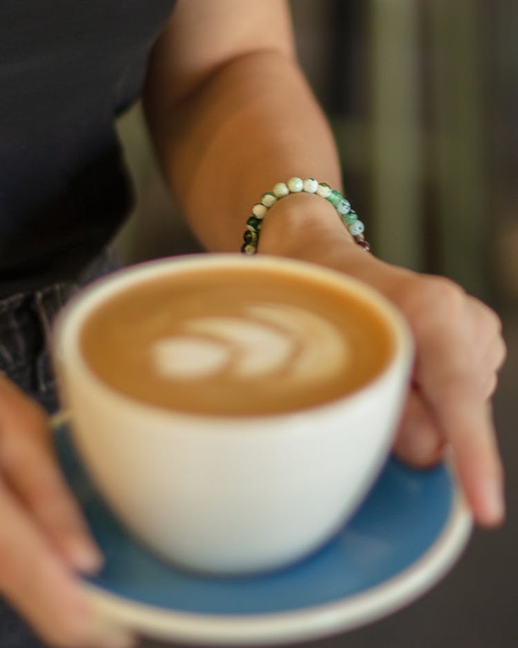 Woman Carrying Coffee With Cream