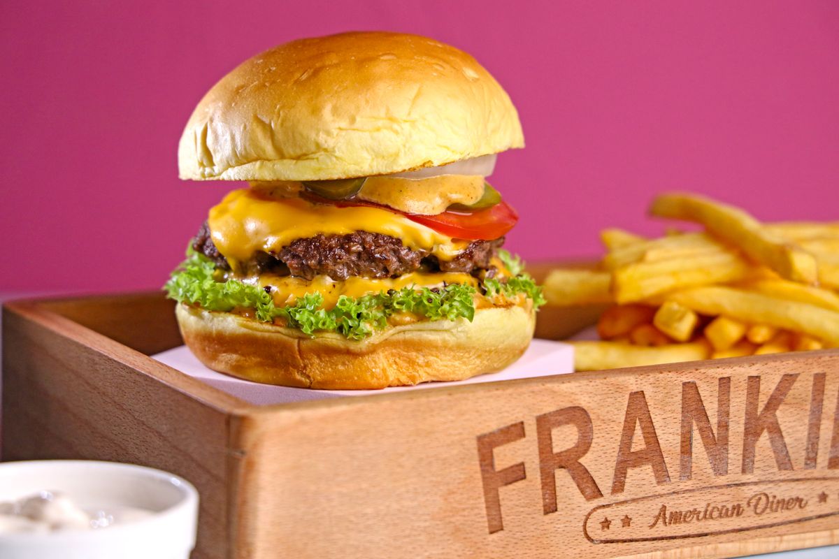 Delicious grilled diner melt burger oozing with melted cheese